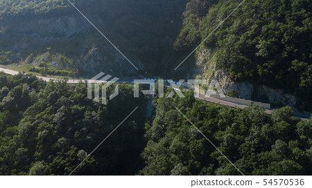 Curved asphalt highway road in mountains of South Russia 54570536