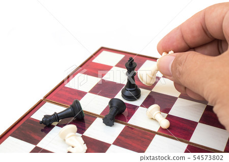 Hand holding chess piece and playing chess game. 54573802