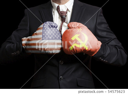 Businessman in boxing gloves with USA and USSR Businessman in boxing gloves with USA and USSR 54575623