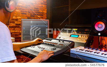 male sound engineer mixing music in home studio male sound engineer mixing music in home studio 54577676