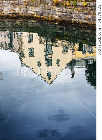 reflection of an old house in canal water 54579325