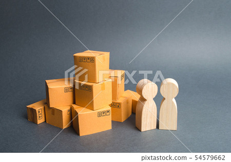 Two human figures stand near a pile of boxes 54579662