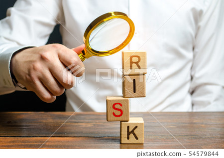 A man explores a tower of cubes risk 54579844