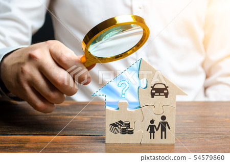 A man examines the missing piece of the puzzle A man examines the missing piece of the puzzle 54579860