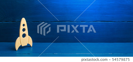 A wooden rocket on a blue background A wooden rocket on a blue background 54579875