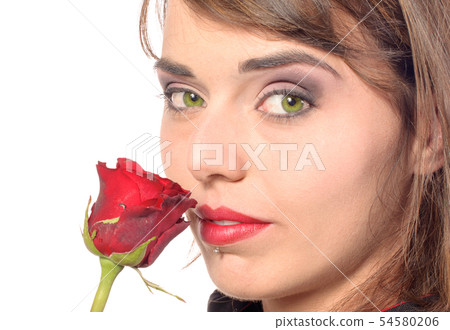 smiling girl dressed in a black cape smells a red smiling girl dressed in a black cape smells a red 54580206