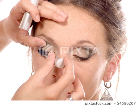 pretty young woman is make up 54580207