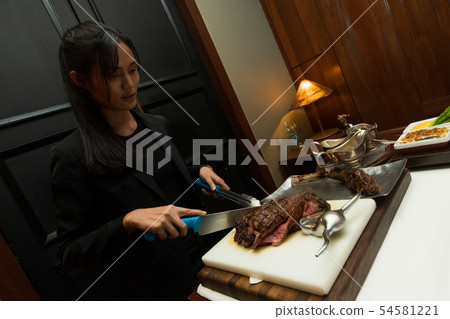 Woman Black hair have Lunch big piece Steak grill Woman Black hair have Lunch big piece Steak grill 54581221