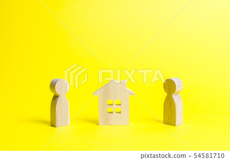 Two persons and a wooden house in between.  54581710