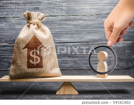 money bag with up arrow and man figurine on scales 54581902