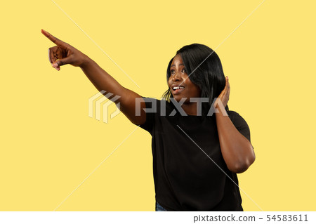 Young african woman isolated on yellow studio background, facial expression 54583611