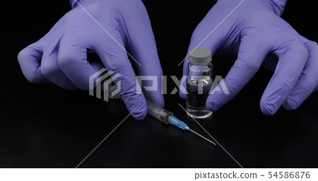 Doctor's hands with syringe, ampoule Doctor's hands with syringe, ampoule 54586876