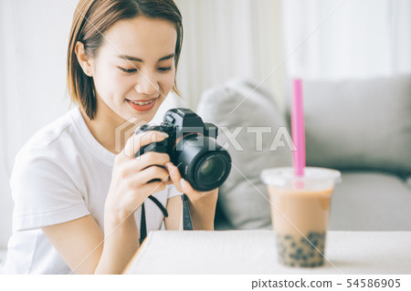 Young woman taking tapioca milk tea with camera Young woman taking tapioca milk tea with camera 54586905