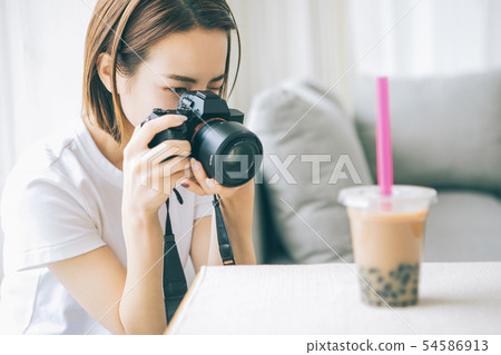 Young woman taking tapioca milk tea with camera Young woman taking tapioca milk tea with camera 54586913