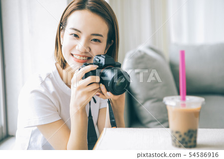 Young woman taking tapioca milk tea with camera Young woman taking tapioca milk tea with camera 54586916