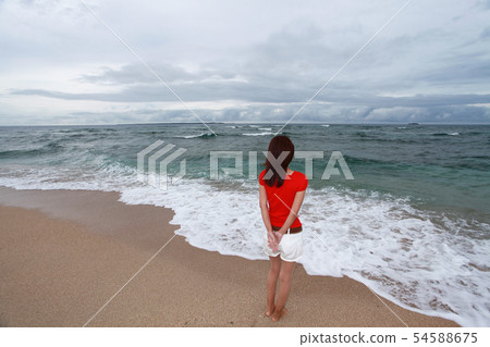 A woman relaxing on the beautiful beach of Okinawa A woman relaxing on the beautiful beach of Okinawa 54588675