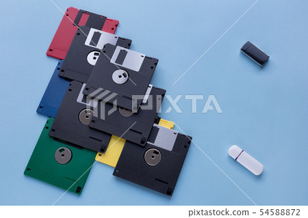 Floppy disks vs small flash drives. Isolated. Floppy disks vs small flash drives. Isolated. 54588872