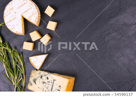 Cheese with mold with a sprig of thyme on a slate Board 54590137