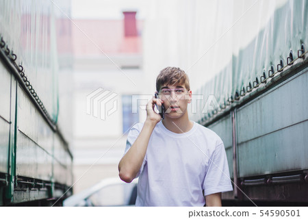 a young man in an empty white t-shirt a young man in an empty white t-shirt 54590501