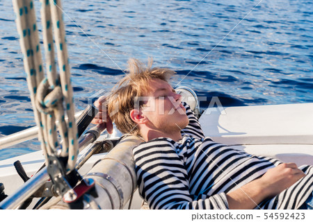 young sailor dozing while calm 54592423