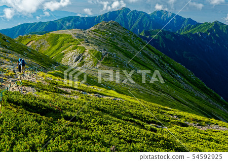 Mountain climbers who go along the ridge line of the Central Alps and the mountains in the direction of Kugidake 54592925