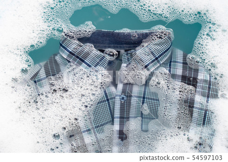 Shirt soak in powder detergent water dissolution. Shirt soak in powder detergent water dissolution. 54597103