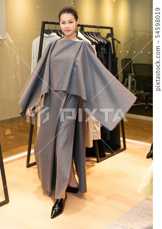 Woman in sensual dress present and fitting cloth Woman in sensual dress present and fitting cloth 54598019
