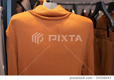 Fashion Design Clothes on Display rack in retail Fashion Design Clothes on Display rack in retail 54598043