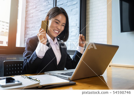 Happy asian businesswoman holding credit card 54598746