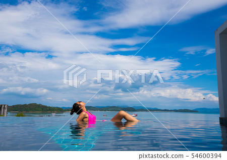 Skinny Tanned skin asian woman bikini swim pool 54600394
