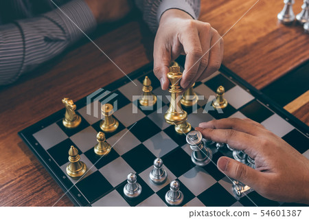 Intelligent businessman playing chess game Intelligent businessman playing chess game 54601387