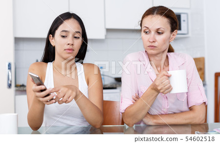 Daughter uses smartphone Daughter uses smartphone 54602518