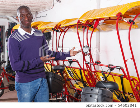 Happy driver of pedicab offering touristic tour 54602841