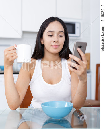 Young girl having breakfast Young girl having breakfast 54602943