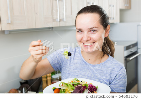 portrait woman eating salad 54603176