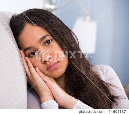 young female sad and thinking on sofa 54603187