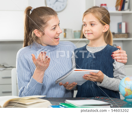 Happy mother rejoices beautiful drawings of her daughter Happy mother rejoices beautiful drawings of her daughter 54603202