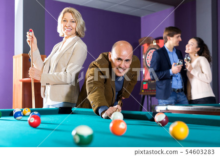 Group of friends playing billiards 54603283
