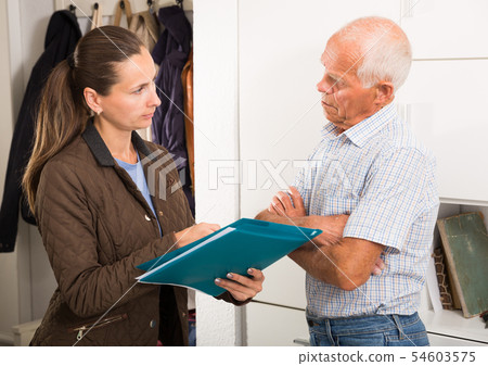 Businesswoman trying to collect arrearages from erderly man at home door 54603575