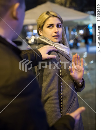 Worried woman and stranger adult man on the street 54603629