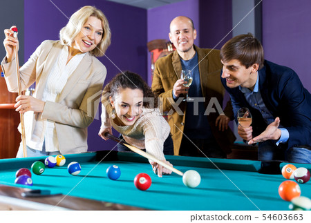 Group of friends playing billiards 54603663