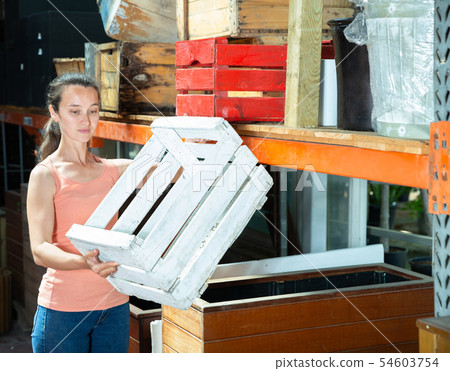 Gardener showing big wooden cases 54603754