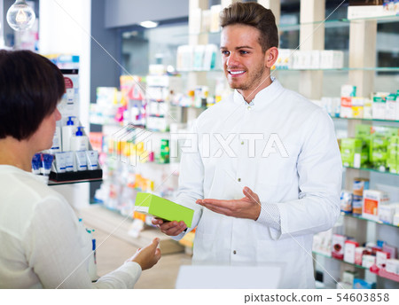pharmacist helping customers pharmacist helping customers 54603858