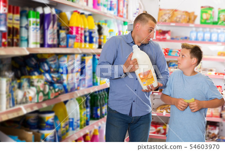 Man doing shopping with preteen boy 54603970