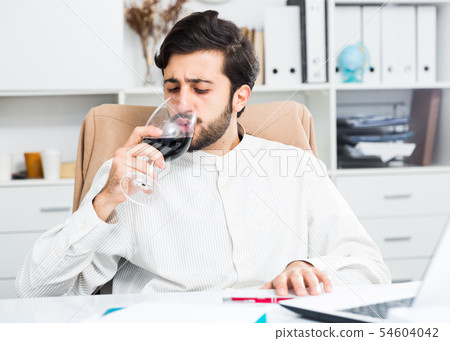 Manager with glass of wine Manager with glass of wine 54604042