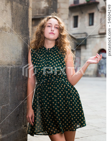 Young sexy woman in dress standing near the stone wall in historical center Young sexy woman in dress standing near the stone wall in historical center 54604249