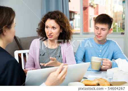 Woman with teenage son meeting financial adviser Woman with teenage son meeting financial adviser 54604267