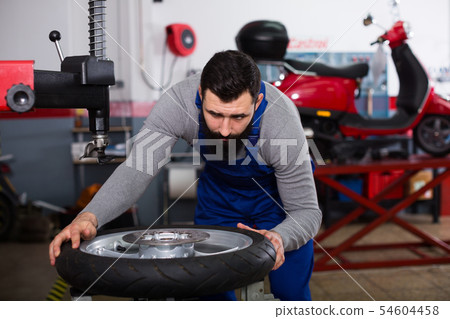 Worker repairing wheel 54604458