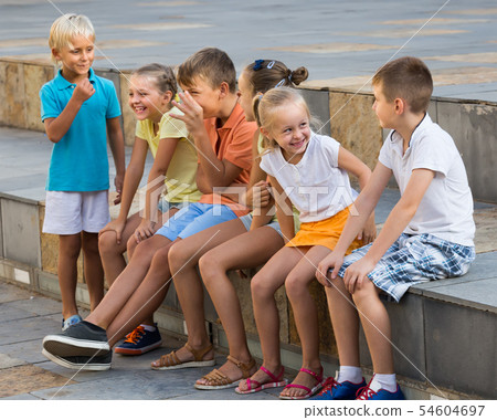 friendly children playing charades outdoors 54604697