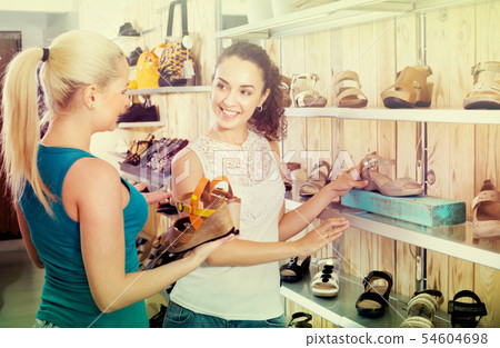 Young women selecting shoes 54604698